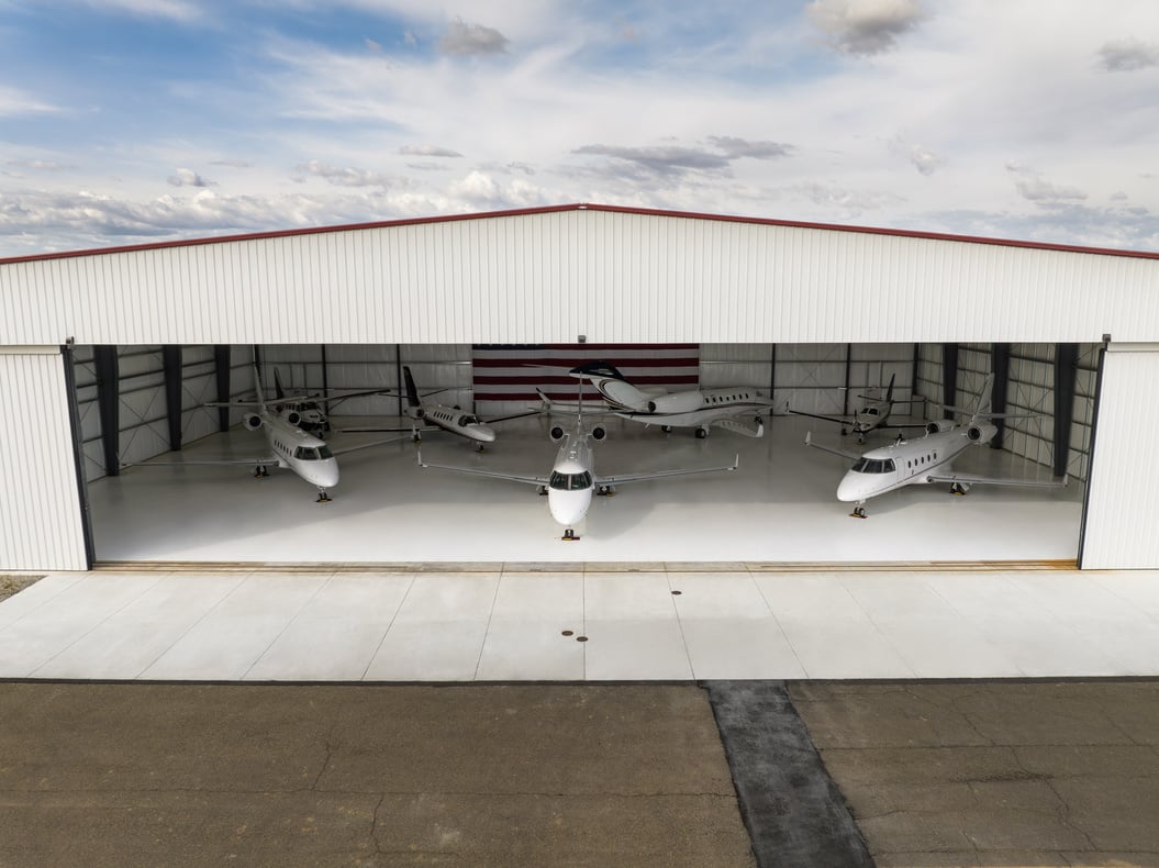 Airplane Hangar With Private Jets Parked Inside